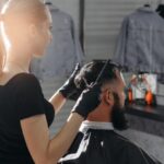 woman-barber-cutting-hair-bearded-man_230325-406
